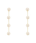 Gold dipped linear drop earrings featuring a vertical row of 6mm faux pearls on a white background from The Pink Doxie Boutique.