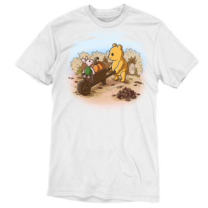 Premium Cotton T-shirt_TeeTurtle white A Perfect Autumn Day Premium Cotton T-shirt featuring a bear pulling a wagon filled with pumpkins while a little mouse rides along, surrounded by autumn bushes, fallen leaves, and tree stumps on a crisp fall day.