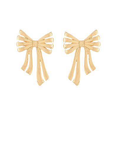 Gold-tone metal bow statement earrings with flowing ribbon detail displayed on a white background from The Pink Doxie Boutique.