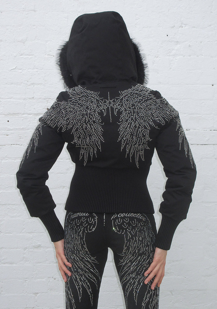 Back view of a black reversible puffer jacket with wing designs and a hood, showcasing the ribbed waist and cuffs.