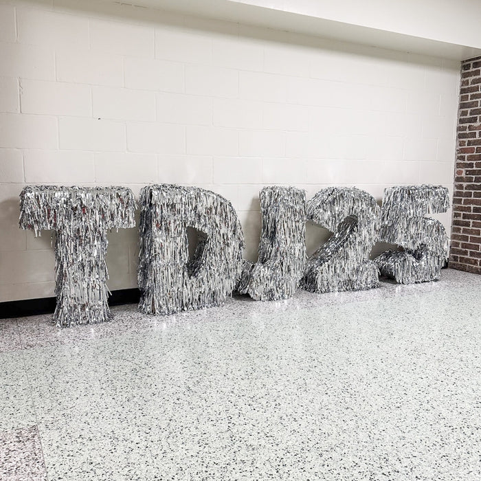Decorative metallic tinsel letters in marquee style