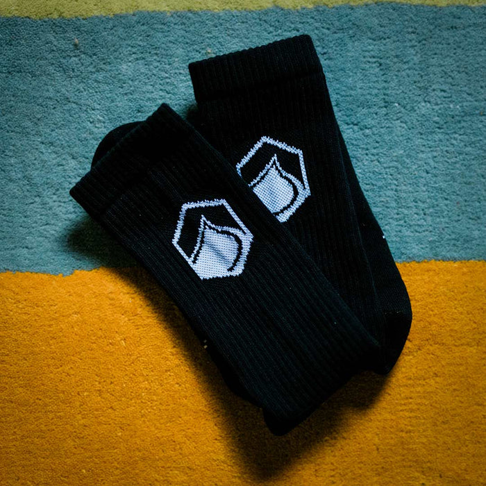 LF x Stinky Crew Socks on a colorful carpet and white hexagon logo.