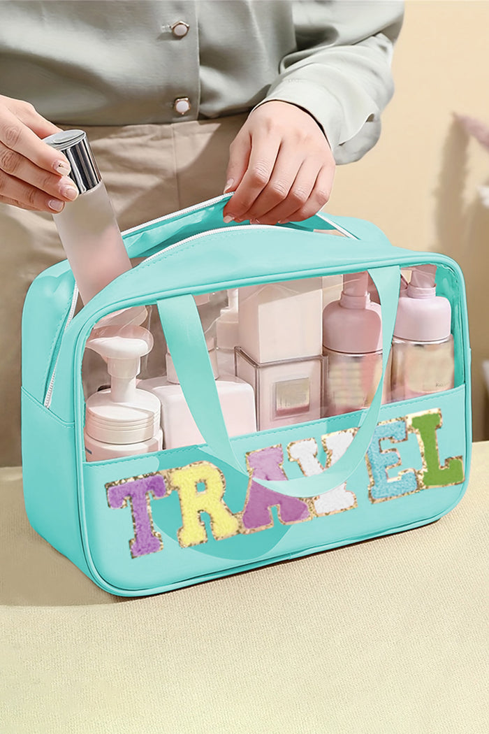 Mint green clear PVC makeup bag with chenille TRAVEL lettering and top handles, filled with beauty products, from The Pink Doxie Boutique.