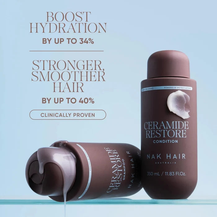 Nak Hair Ceramide Restore Condition hair conditioner bottle in a dark brown shade, shown standing upright and lying on its side with conditioner dripping, against a light blue background with promotional text.