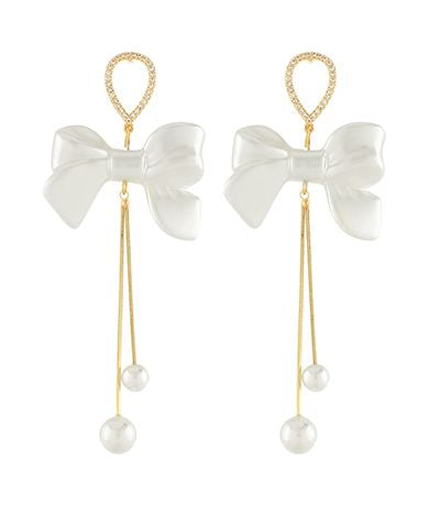 White pearl bow long tail earrings with crystal accents and dangling faux pearl drops from The Pink Doxie Boutique.