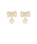 Gold-tone ribbon drop earrings with crystal details and a faux pearl accent displayed on a white background from The Pink Doxie Boutique.