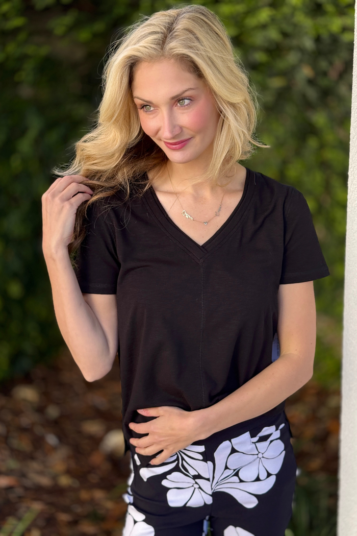 Relaxed fit black tribal v neck tee styled with floral pants